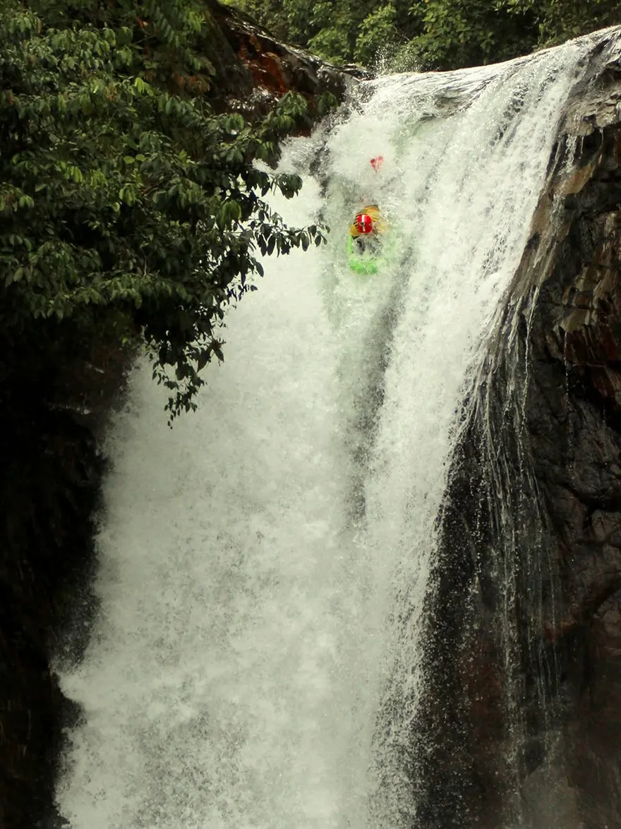 Josh Galt III riding a riverboard over the 15-metre Hollín Chico waterfall in Ecuador